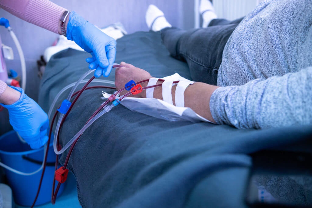 Medical professional managing a patient's access site to share helpful tips for dialysis patients.